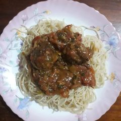 A picture of Coconut and tamarind meat balls, served with spaghetti.