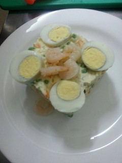 A picture of Russian salad with shrimps.