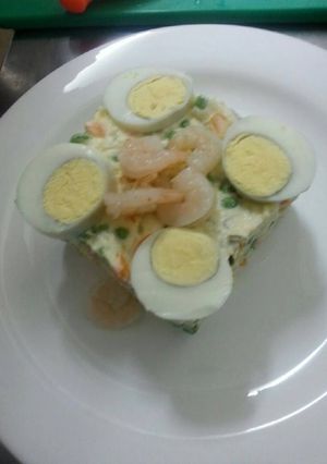 A picture of Russian salad with shrimps.