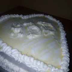 A picture of Vanilla Cake iced with whipped cream.