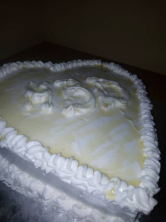 A picture of Vanilla Cake iced with whipped cream.
