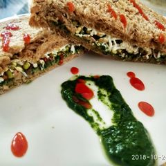A picture of Spinach and sprout cheese sandwich.