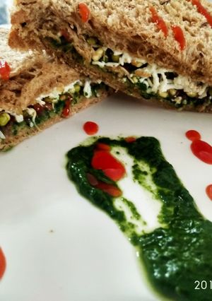 A picture of Spinach and sprout cheese sandwich.