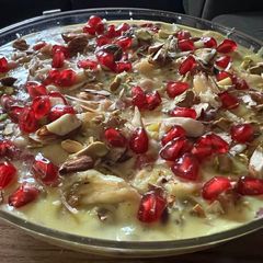 A picture of Vermicelli fruit custard with pomegranate.