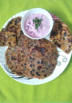 A picture of Methi Aloo Paratha and Beetroot Raita.