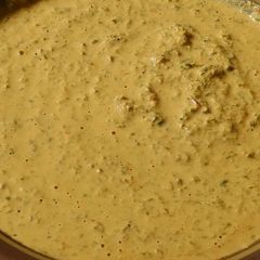 A picture of Flavorful aromatic spicy chutney with curry and mint leaves.