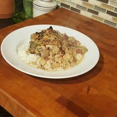 A picture of Roast Chicken Thighs in a Sautéed Mushroom Parmasan Garlic Cream.