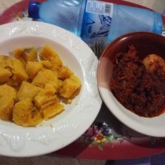 Boiled Ripe Plantain with Egg and Cow Skin (Kpomo) Sauce A picture of Boiled Ripe Plantain with Egg and Cow Skin (Kpomo) Sauce.