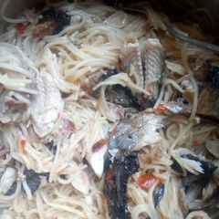 A picture of Spaghetti with fried fish.