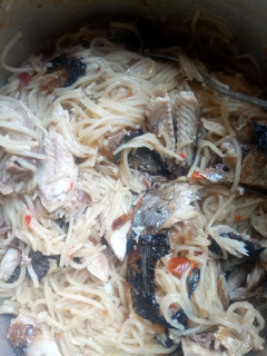 A picture of Spaghetti with fried fish.