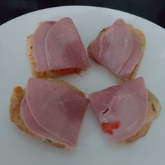 A picture of My open toasted Garlic Cheese bread with ham + Tomato 🤩.
