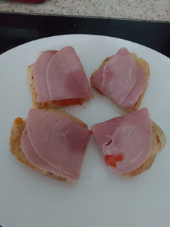 A picture of My open toasted Garlic Cheese bread with ham + Tomato 🤩.