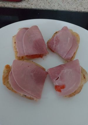 A picture of My open toasted Garlic Cheese bread with ham + Tomato 🤩.