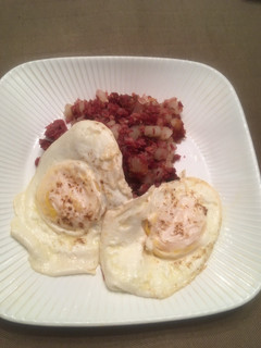 A picture of Corned Beef Hash with Eggs Over Easy.