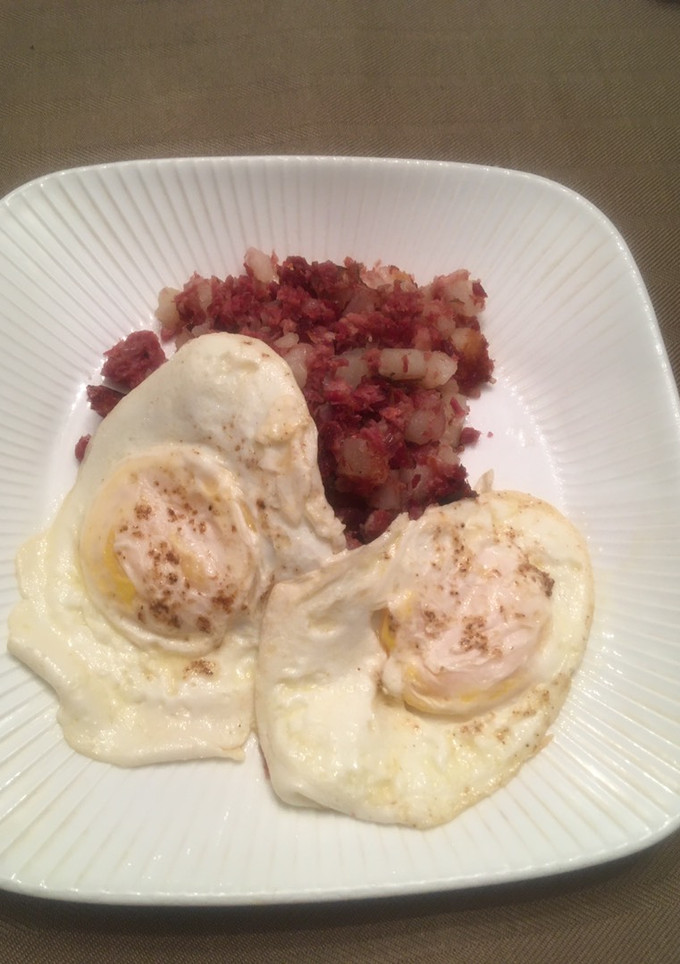 A picture of Corned Beef Hash with Eggs Over Easy.