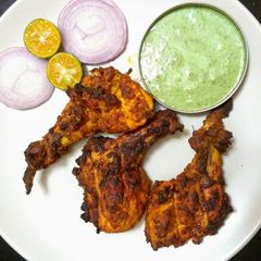A picture of Tandoori chicken in oven.