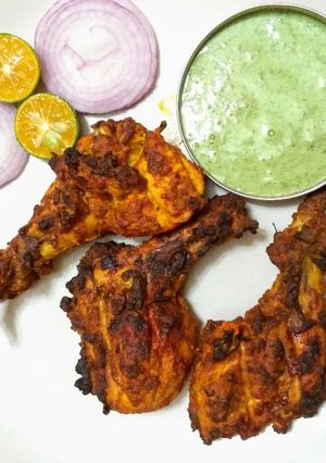 A picture of Tandoori chicken in oven.