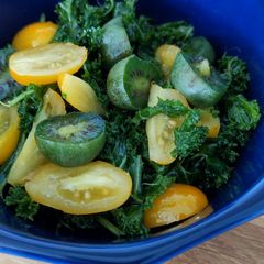 A picture of Raw kale, tomato and kiwiberry salad.
