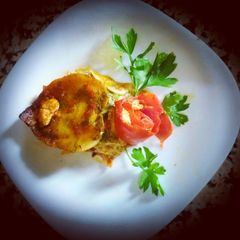 A ravioli stuffed with pumpkin and cheese A picture of A ravioli stuffed with pumpkin and cheese.