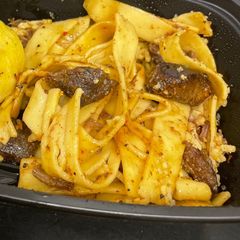 A picture of Crockpot stew meat over egg noodles.