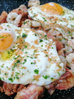 Una foto de Huevos rotos con pota y gambas
