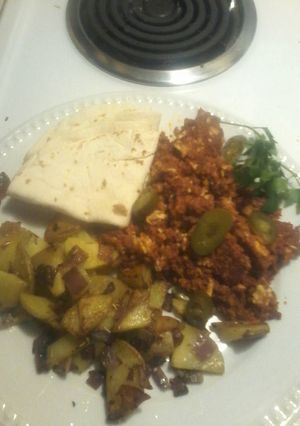 A picture of Chorizo and eggs, garlic crunchy potatoes.