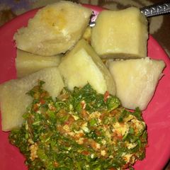 A picture of Boiled yam with vegetable sauce.