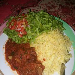 A picture of Rice nd stew with salad..