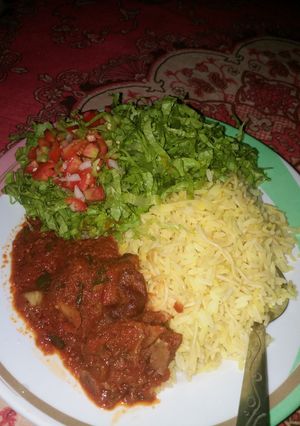 A picture of Rice nd stew with salad..