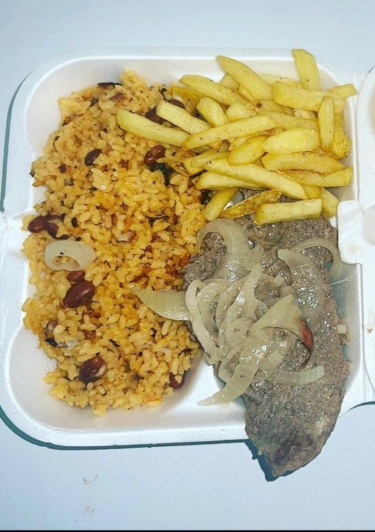 Una foto de Arroz con habichuelas, bistec encebollado y papas fritas