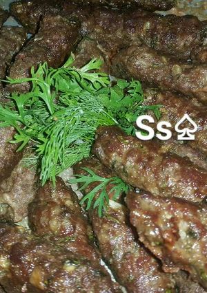 A picture of Grilled Kofta with Yellow Rice and Tahini Salad 🍲.