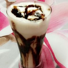 A picture of Chocolate shake with vanilla Ice-cream.
