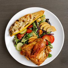A picture of Roasted Chicken with Stuffed Squash and Salad.