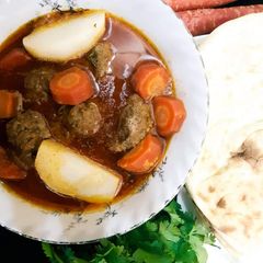 A picture of Shab Daig with Tandoori Roti (meetball with turnip & carrot in curry).