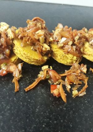 A picture of Dhokla disk with salsa topping.