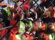 Una foto de brochetas de res