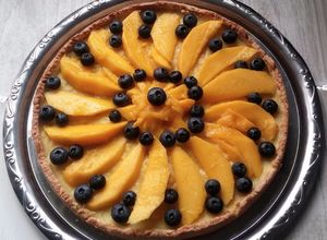 Una foto de Tarta de mango y arándanos