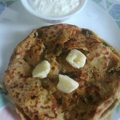 A picture of Mooli ka paratha with curd And tea.
