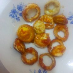 A picture of Boiled eggs in tomato sauce.