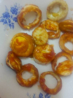 A picture of Boiled eggs in tomato sauce.