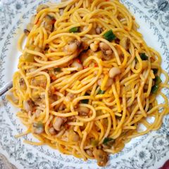 A picture of Jollof spaghetti and beans.
