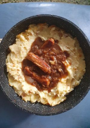 A picture of Bangers an Mash with Beef Gravy and fried Onions.