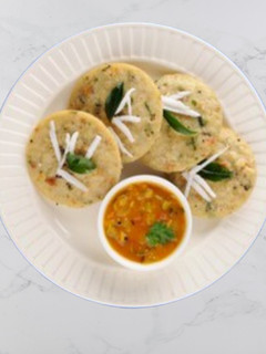 A picture of Carrot - Coriander Idli With Sambar.