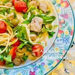 A picture of Spaghetti with tuna, green olives and cherry tomatoes.