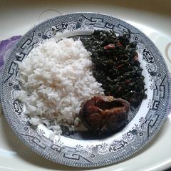 A picture of White rice with vegetable source.