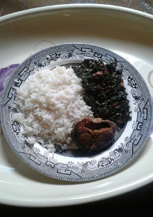 A picture of White rice with vegetable source.