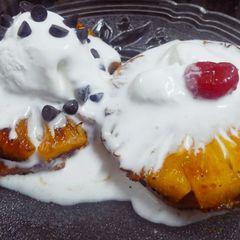 A picture of Caramelized pineapple with nutty ice cream.