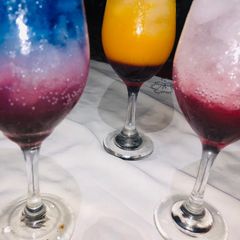 A picture of Rose and layered blue Paradise mocktail.