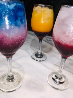 A picture of Rose and layered blue Paradise mocktail.