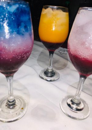 A picture of Rose and layered blue Paradise mocktail.